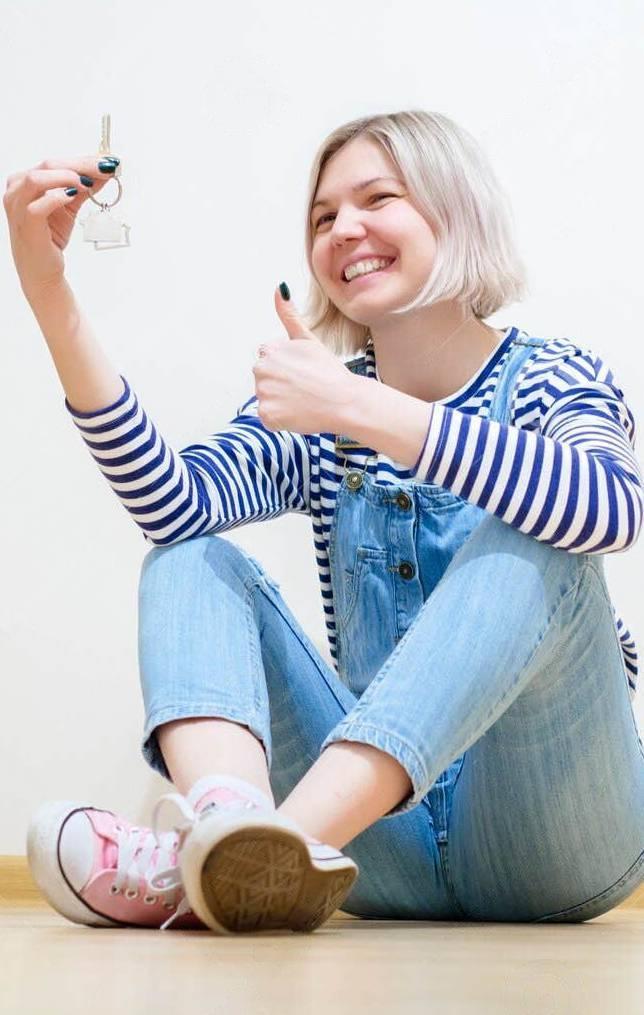 Blonde holding keys of new apartment